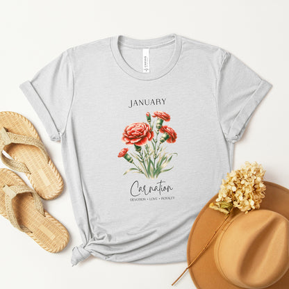 A t-shirt featuring a beautiful carnation for January with traits Devotion, Love, Loyalty. Perfect for January birthdays and floral art lovers. Comfortable and stylish for casual outings or celebrations. Bella+Canvas 3001 t-shirt in ash. ReadyShirtAim.com