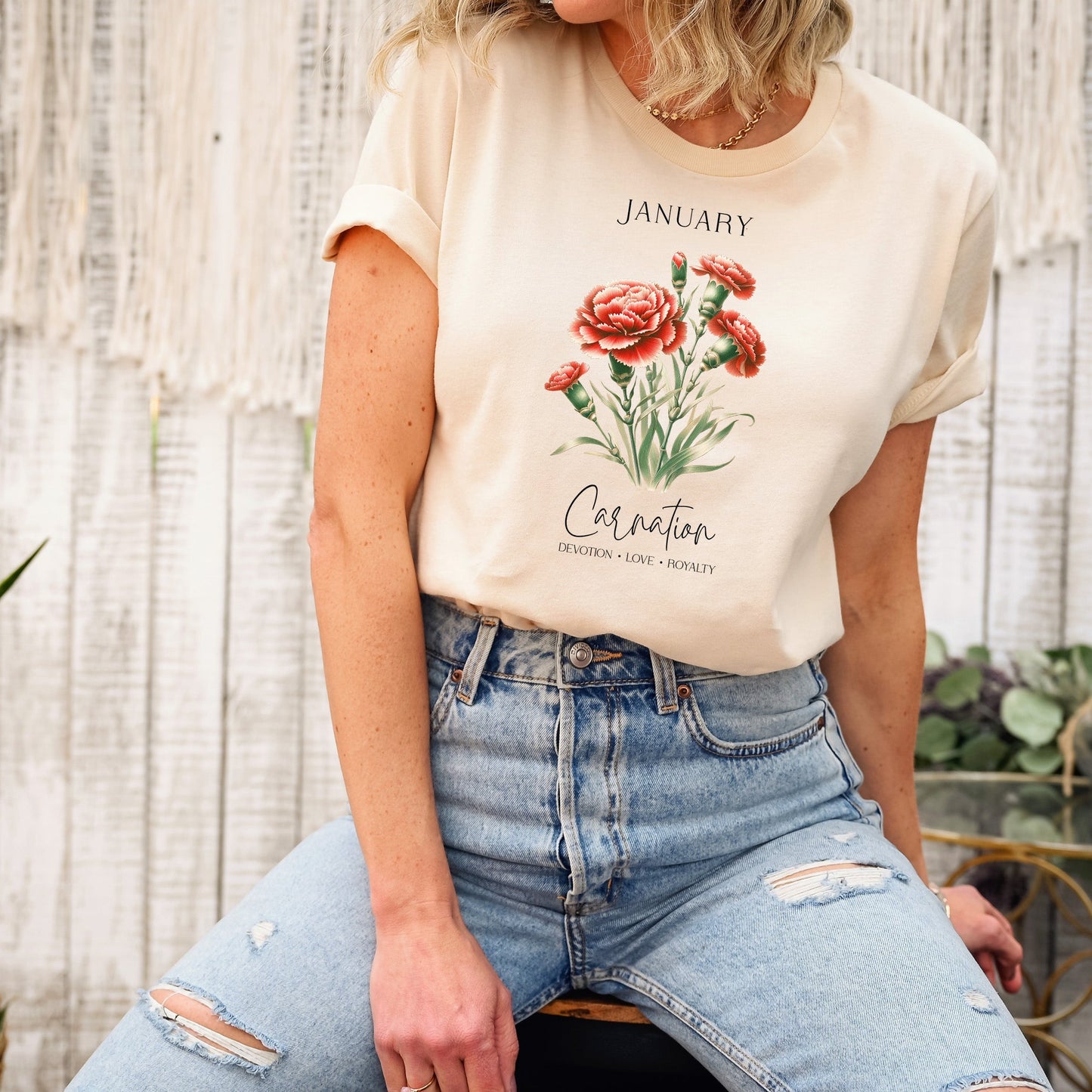 A t-shirt featuring a beautiful carnation for January with traits Devotion, Love, Loyalty. Perfect for January birthdays and floral art lovers. Comfortable and stylish for casual outings or celebrations. Bella+Canvas 3001 t-shirt in soft cream. ReadyShirtAim.com