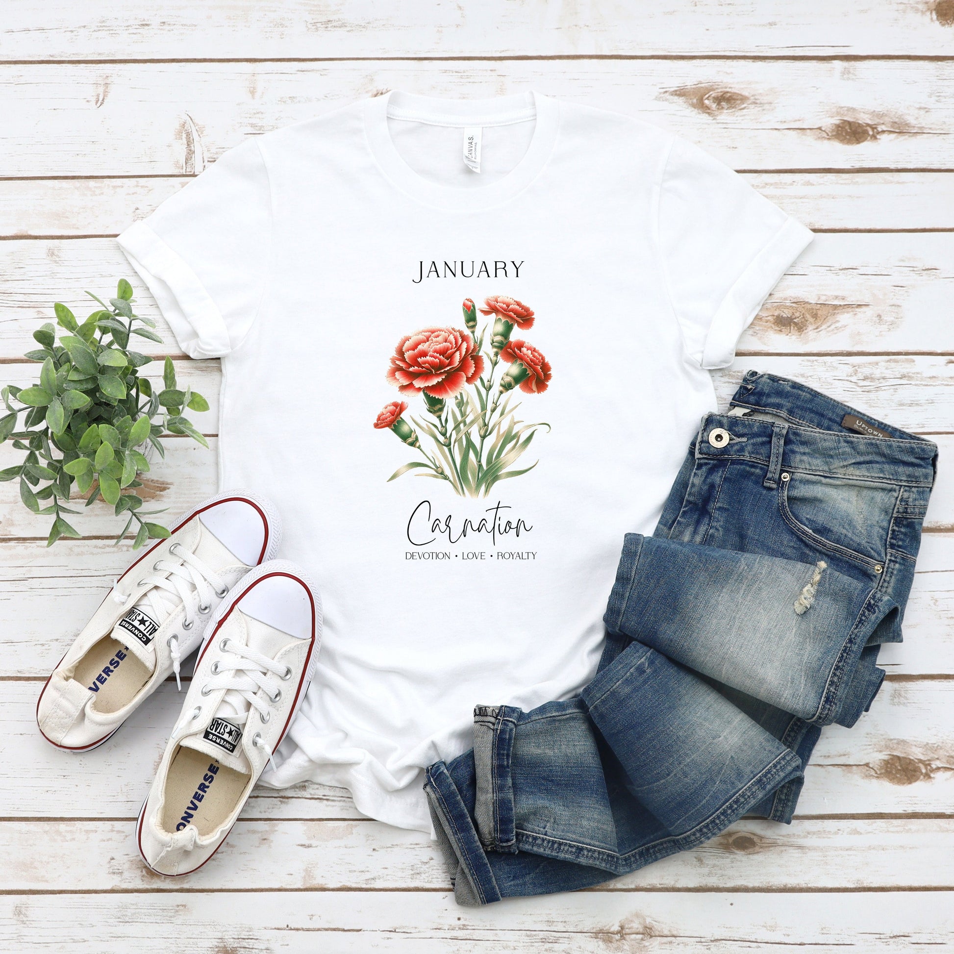 A t-shirt featuring a beautiful carnation for January with traits Devotion, Love, Loyalty. Perfect for January birthdays and floral art lovers. Comfortable and stylish for casual outings or celebrations. Bella+Canvas 3001 t-shirt in white. ReadyShirtAim.com