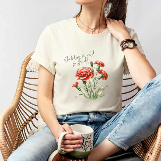 A t-shirt featuring a beautiful carnation for January with the quote “She believed she could, so she did.” Perfect for January birthdays and floral art lovers. Comfortable and stylish for casual outings or celebrations. Bella+Canvas 3001 t-shirt in natural. ReadyShirtAim.com