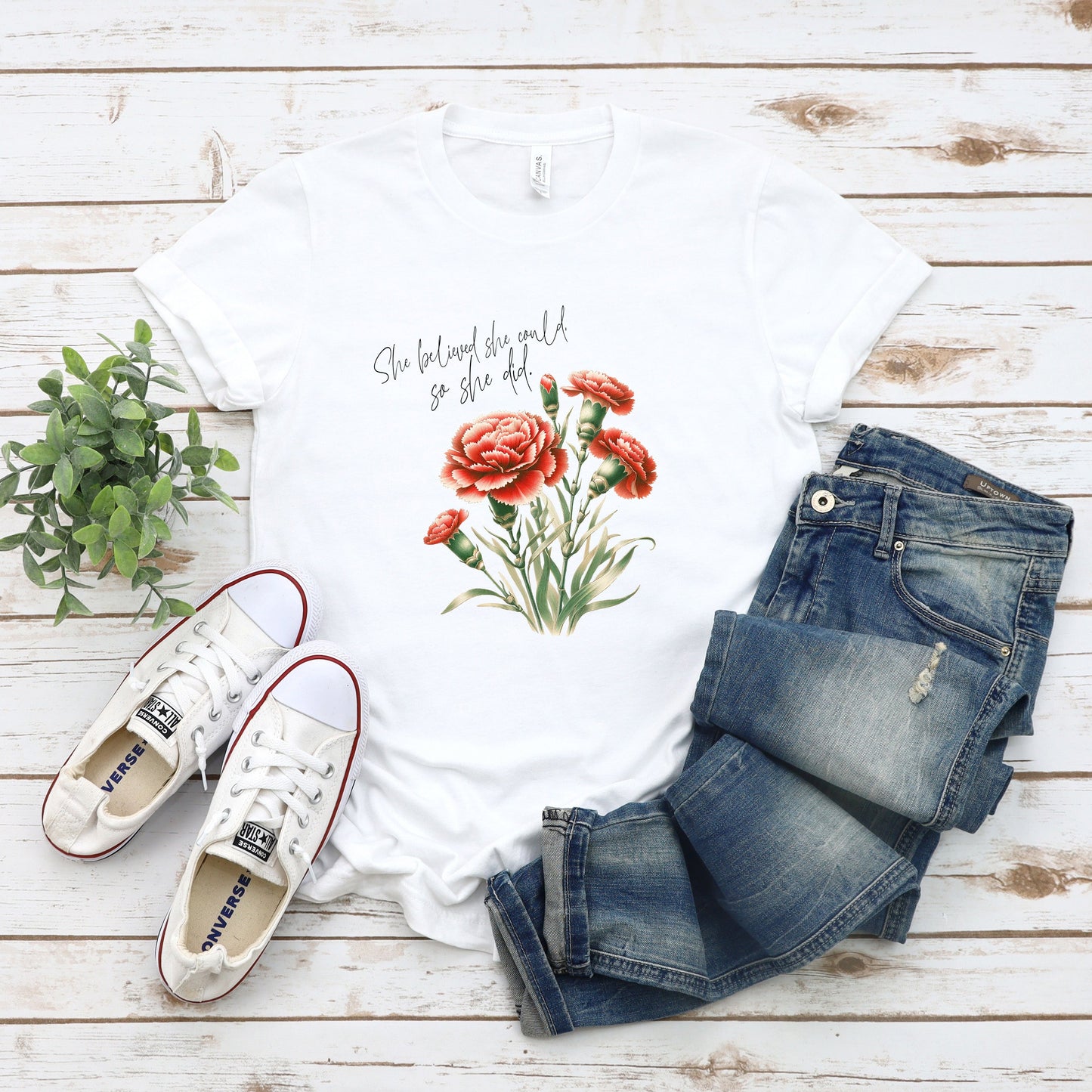 A t-shirt featuring a beautiful carnation for January with the quote “She believed she could, so she did.” Perfect for January birthdays and floral art lovers. Comfortable and stylish for casual outings or celebrations. Bella+Canvas 3001 t-shirt in white. ReadyShirtAim.com