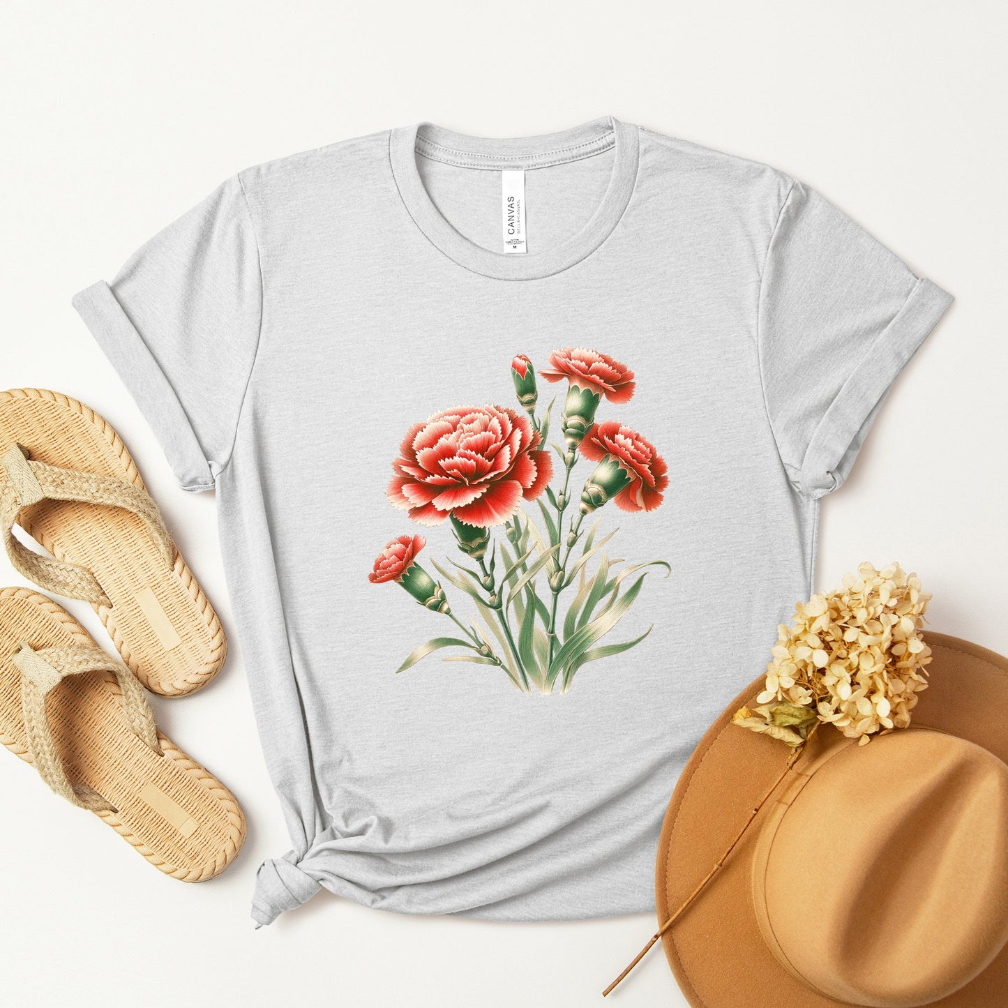 A t-shirt featuring a beautiful carnation for January. Perfect for January birthdays and floral art lovers. Comfortable and stylish for casual outings or celebrations. Bella+Canvas 3001 t-shirt in ash. ReadyShirtAim.com