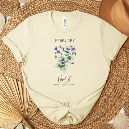 A t-shirt featuring a beautiful violet for February with traits Virtue, Modesty, Humility. Perfect for February birthdays and floral art lovers. Comfortable and stylish for casual outings or celebrations. Bella+Canvas 3001 t-shirt in natural. ReadyShirtAim.com