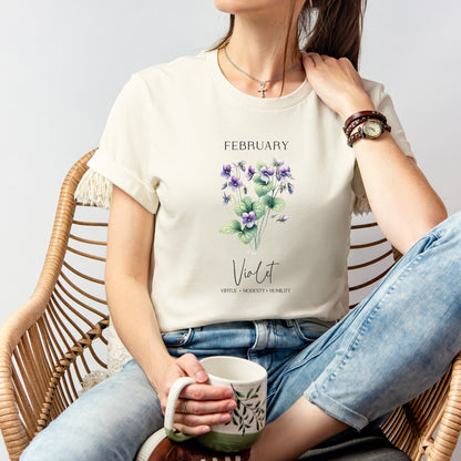 A t-shirt featuring a beautiful violet for February with traits Virtue, Modesty, Humility. Perfect for February birthdays and floral art lovers. Comfortable and stylish for casual outings or celebrations. Bella+Canvas 3001 t-shirt in natural. ReadyShirtAim.com