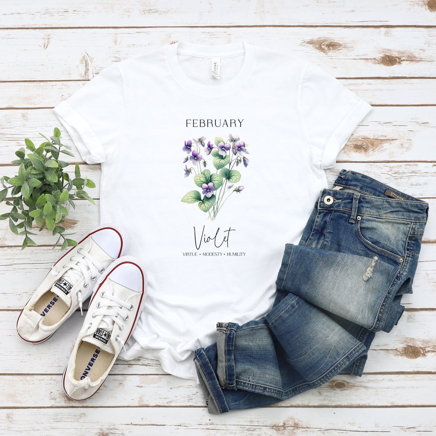 A t-shirt featuring a beautiful violet for February with traits Virtue, Modesty, Humility. Perfect for February birthdays and floral art lovers. Comfortable and stylish for casual outings or celebrations. Bella+Canvas 3001 t-shirt in white. ReadyShirtAim.com