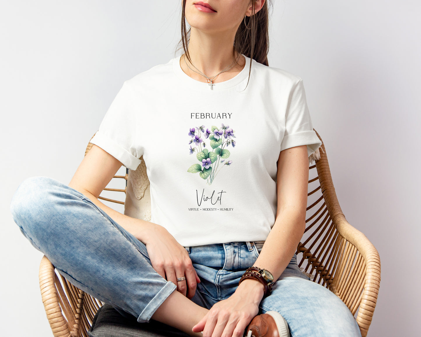 A t-shirt featuring a beautiful violet for February with traits Virtue, Modesty, Humility. Perfect for February birthdays and floral art lovers. Comfortable and stylish for casual outings or celebrations. Bella+Canvas 3001 t-shirt in white. ReadyShirtAim.com