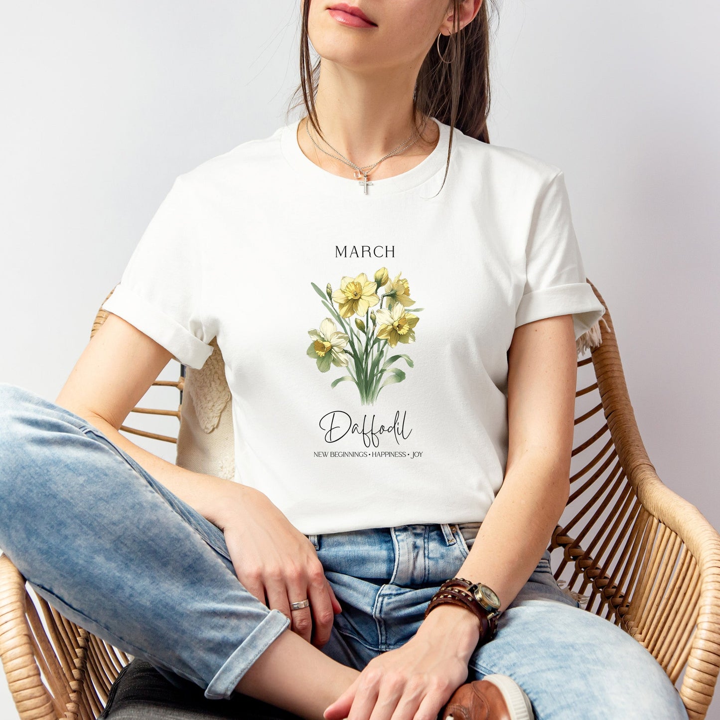 A t-shirt featuring a beautiful daffodil for March with traits New Beginnings, Happiness, Joy. Perfect for March birthdays and floral art lovers. Comfortable and stylish for casual outings or celebrations. Bella+Canvas 3001 t-shirt in white. ReadyShirtAim.com