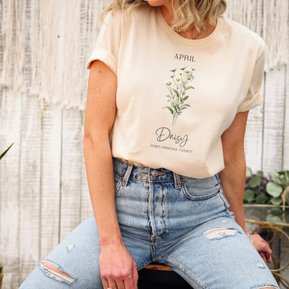 A t-shirt featuring a beautiful daisy for April with traits Purity, Innocence, Loyalty. Perfect for April birthdays and floral art lovers. Comfortable and stylish for casual outings or celebrations. Bella+Canvas 3001 t-shirt in soft cream. ReadyShirtAim.com