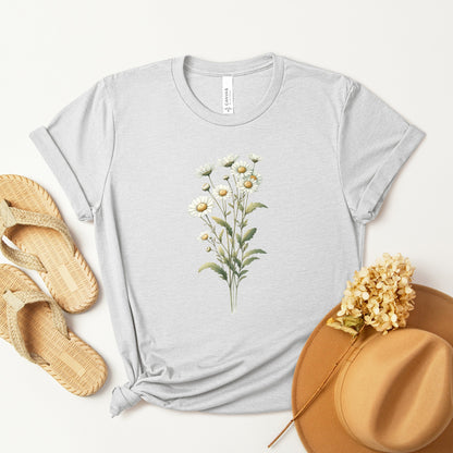 A t-shirt featuring a beautiful daisy for April. Perfect for April birthdays and floral art lovers. Comfortable and stylish for casual outings or celebrations. Bella+Canvas 3001 t-shirt in ash. ReadyShirtAim.com