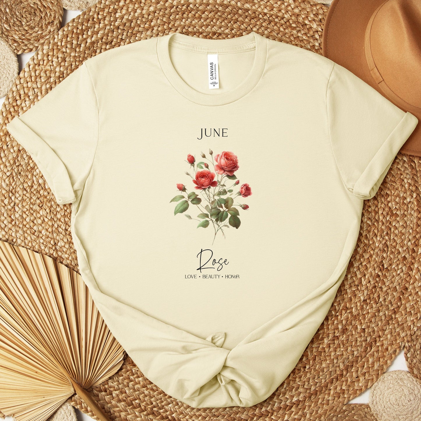 A t-shirt featuring a beautiful rose for June with traits Love, Beauty, Honor. Perfect for June birthdays and floral art lovers. Comfortable and stylish for casual outings or celebrations. Bella+Canvas 3001 t-shirt in natural. ReadyShirtAim.com