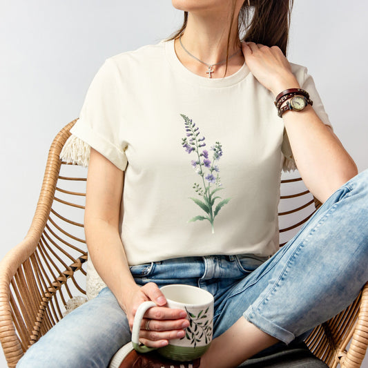 A t-shirt featuring a beautiful larkspur for July. Perfect for July birthdays and floral art lovers. Comfortable and stylish for casual outings or celebrations. Bella+Canvas 3001 t-shirt in natural. ReadyShirtAim.com