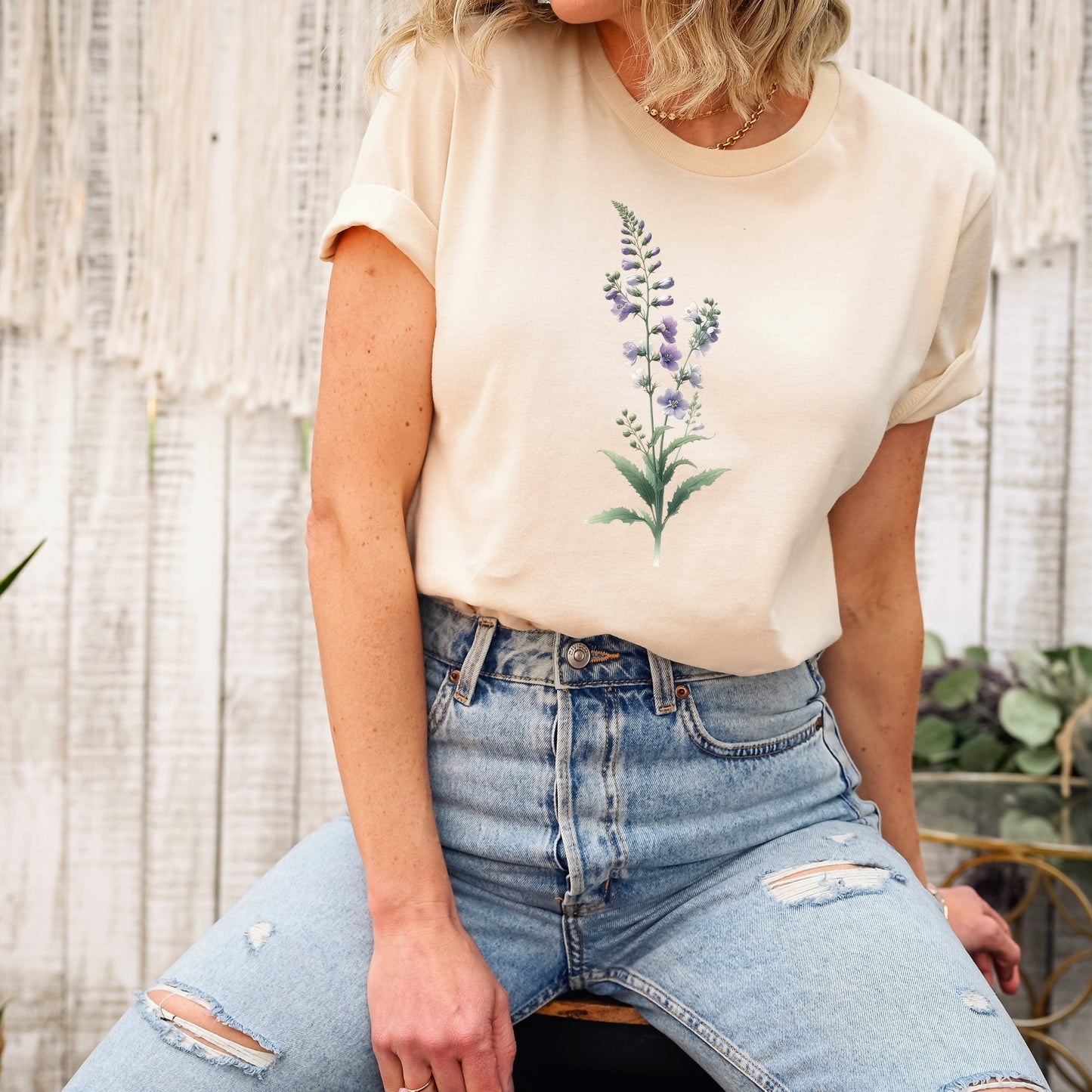 A t-shirt featuring a beautiful larkspur for July. Perfect for July birthdays and floral art lovers. Comfortable and stylish for casual outings or celebrations. Bella+Canvas 3001 t-shirt in soft cream. ReadyShirtAim.com