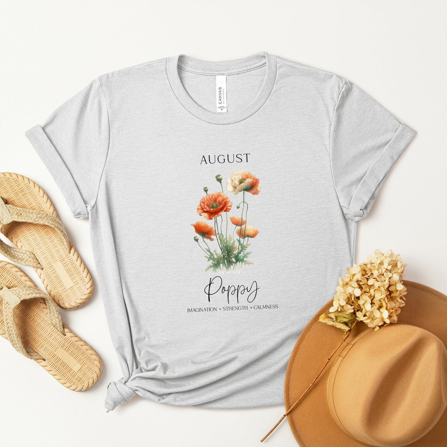 A t-shirt featuring a beautiful poppy for August with traits Imagination, Strength, Calmness. Perfect for August birthdays and floral art lovers. Comfortable and stylish for casual outings or celebrations. Bella+Canvas 3001 t-shirt in ash. ReadyShirtAim.com