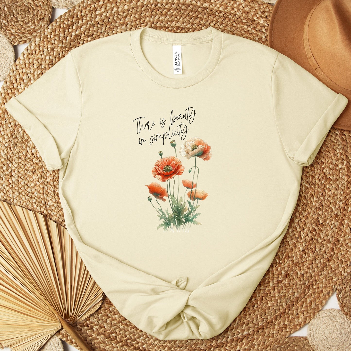 A t-shirt featuring a beautiful poppy for August with the quote “There is beauty in simplicity.” Perfect for August birthdays and floral art lovers. Comfortable and stylish for casual outings or celebrations. Bella+Canvas 3001 t-shirt in natural. ReadyShirtAim.com