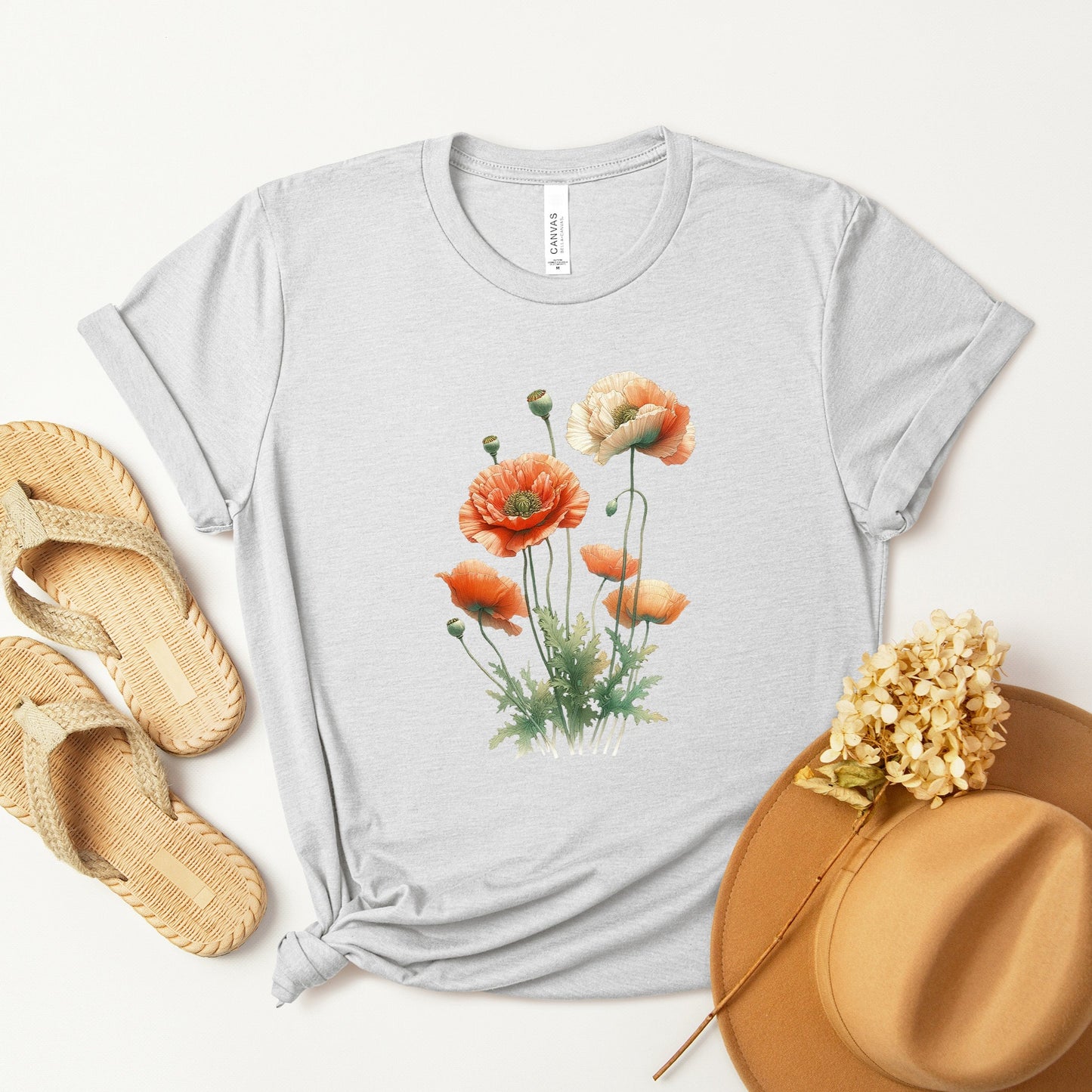 A t-shirt featuring a beautiful poppy for August. Perfect for August birthdays and floral art lovers. Comfortable and stylish for casual outings or celebrations. Bella+Canvas 3001 t-shirt in ash. ReadyShirtAim.com