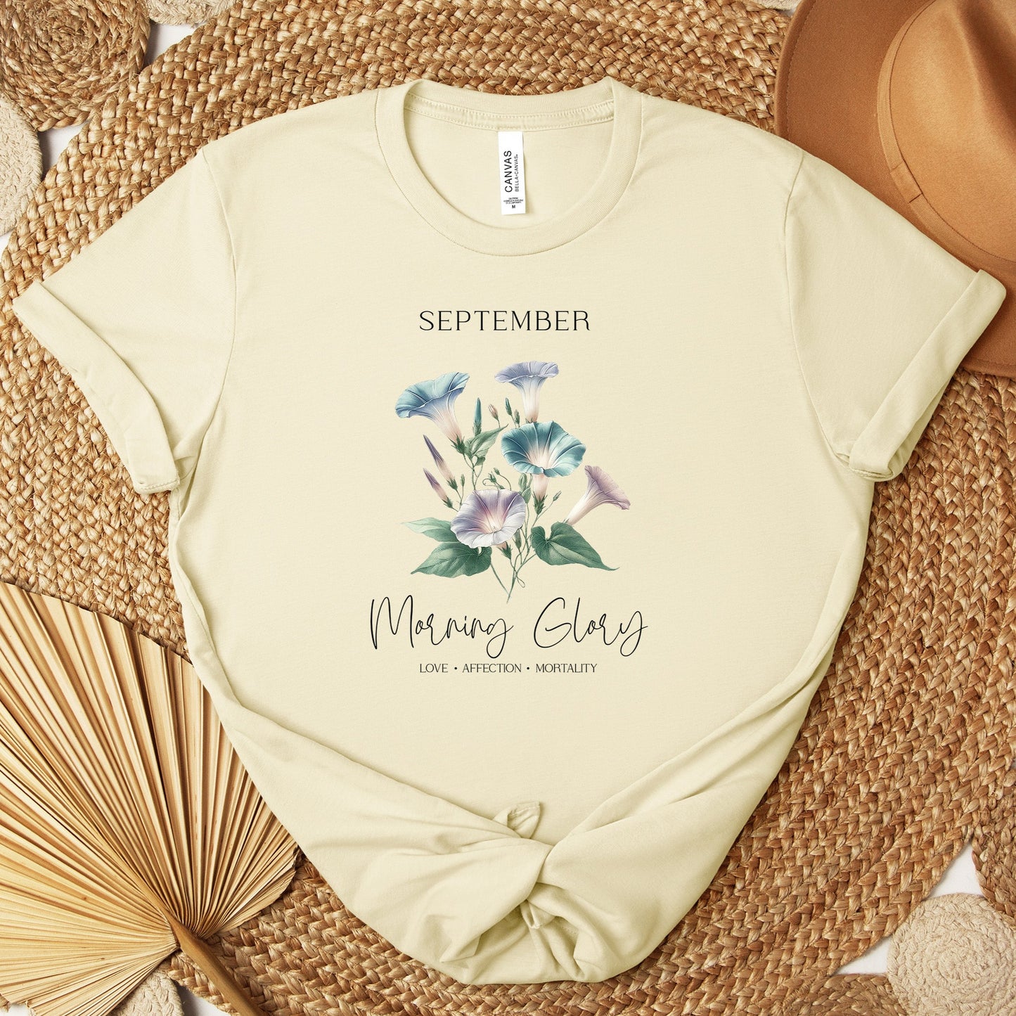 A t-shirt featuring a beautiful morning glory for September with traits Love, Affection, Mortality. Perfect for September birthdays and floral art lovers. Comfortable and stylish for casual outings or celebrations. Bella+Canvas 3001 t-shirt in natural. ReadyShirtAim.com