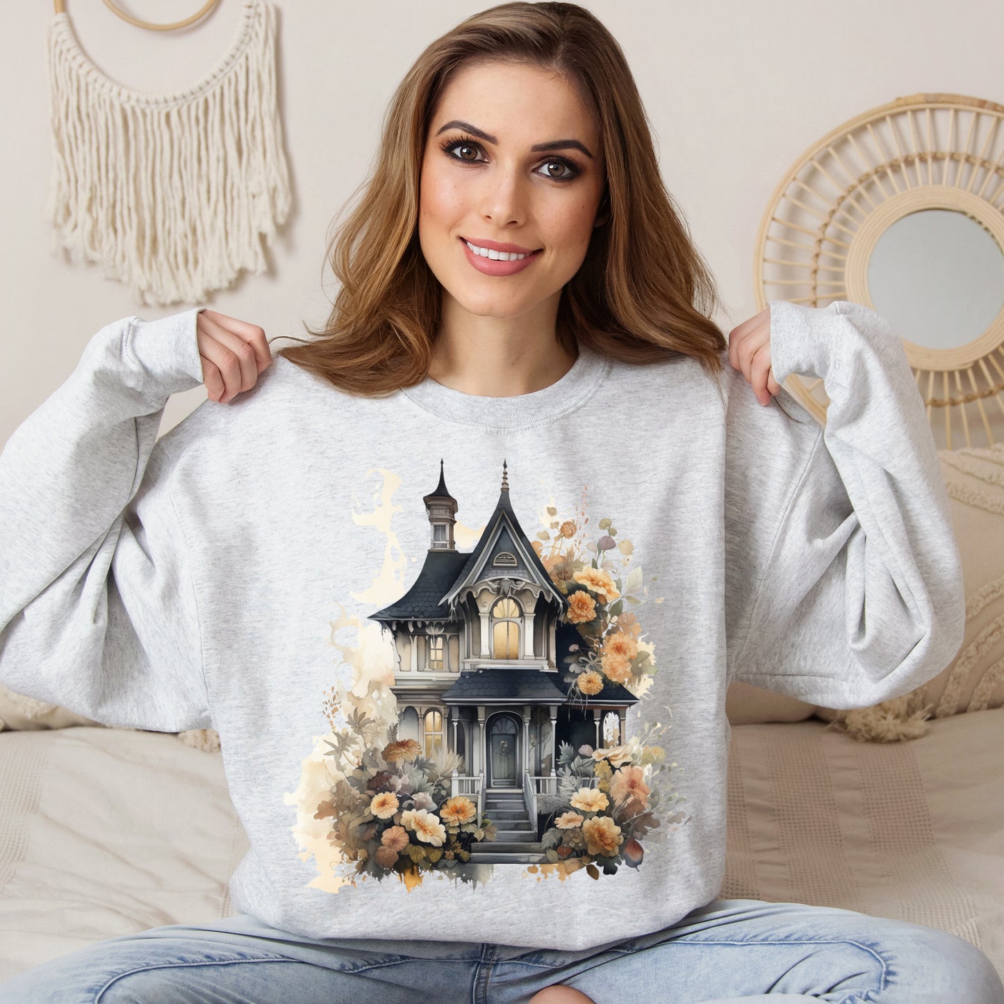 Halloween Boho Sweatshirt for Women featuring a haunted house illustration with boho design elements. Perfect for autumn festivities and casual wear. Available in multiple dark and light colors and sizes. Gildan 18000 sweatshirt in Ash. ReadyShirtAim.com