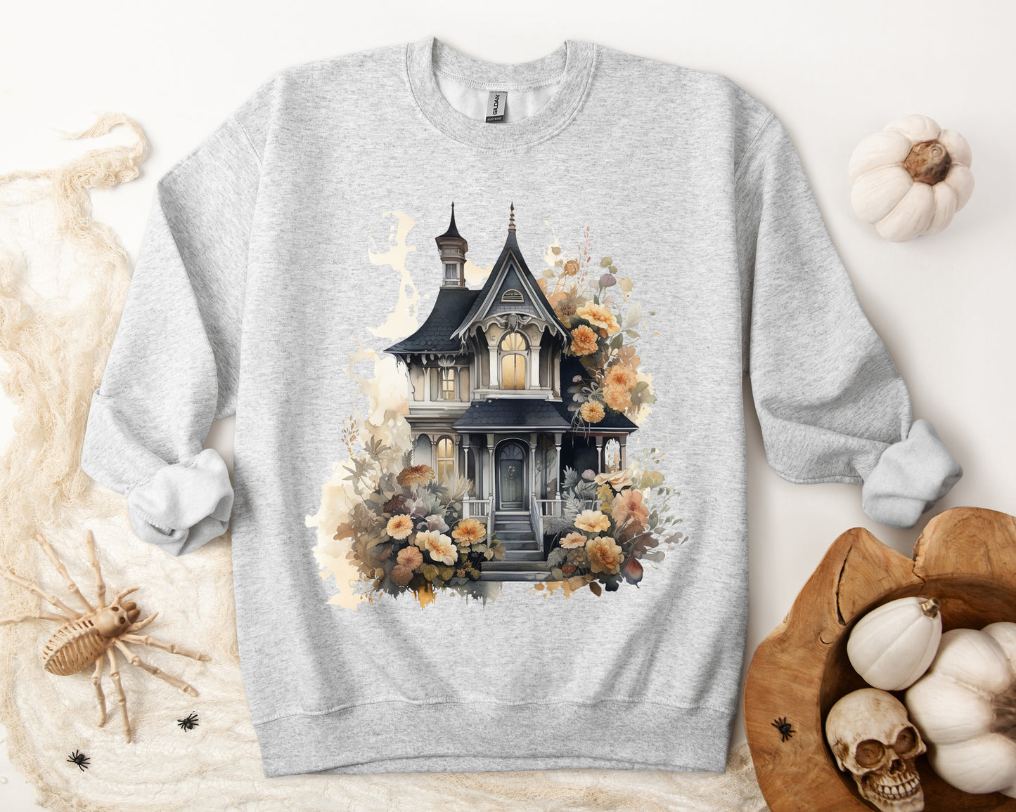 Halloween Boho Sweatshirt for Women featuring a haunted house illustration with boho design elements. Perfect for autumn festivities and casual wear. Available in multiple dark and light colors and sizes. Gildan 18000 sweatshirt in Ash. ReadyShirtAim.com