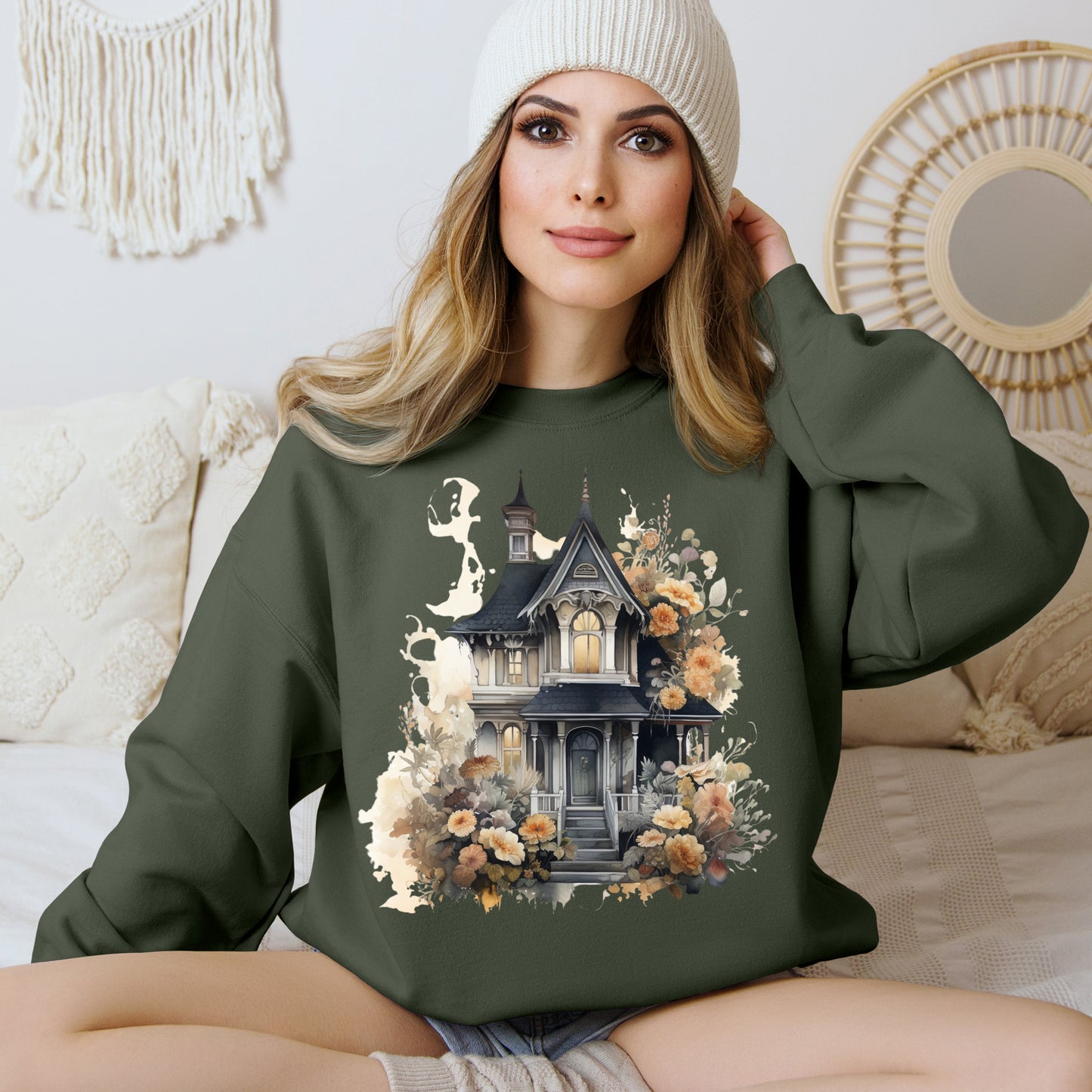 Halloween Boho Sweatshirt for Women featuring a haunted house illustration with boho design elements. Perfect for autumn festivities and casual wear. Gildan 18000 sweatshirt in Military Green. ReadyShirtAim.com