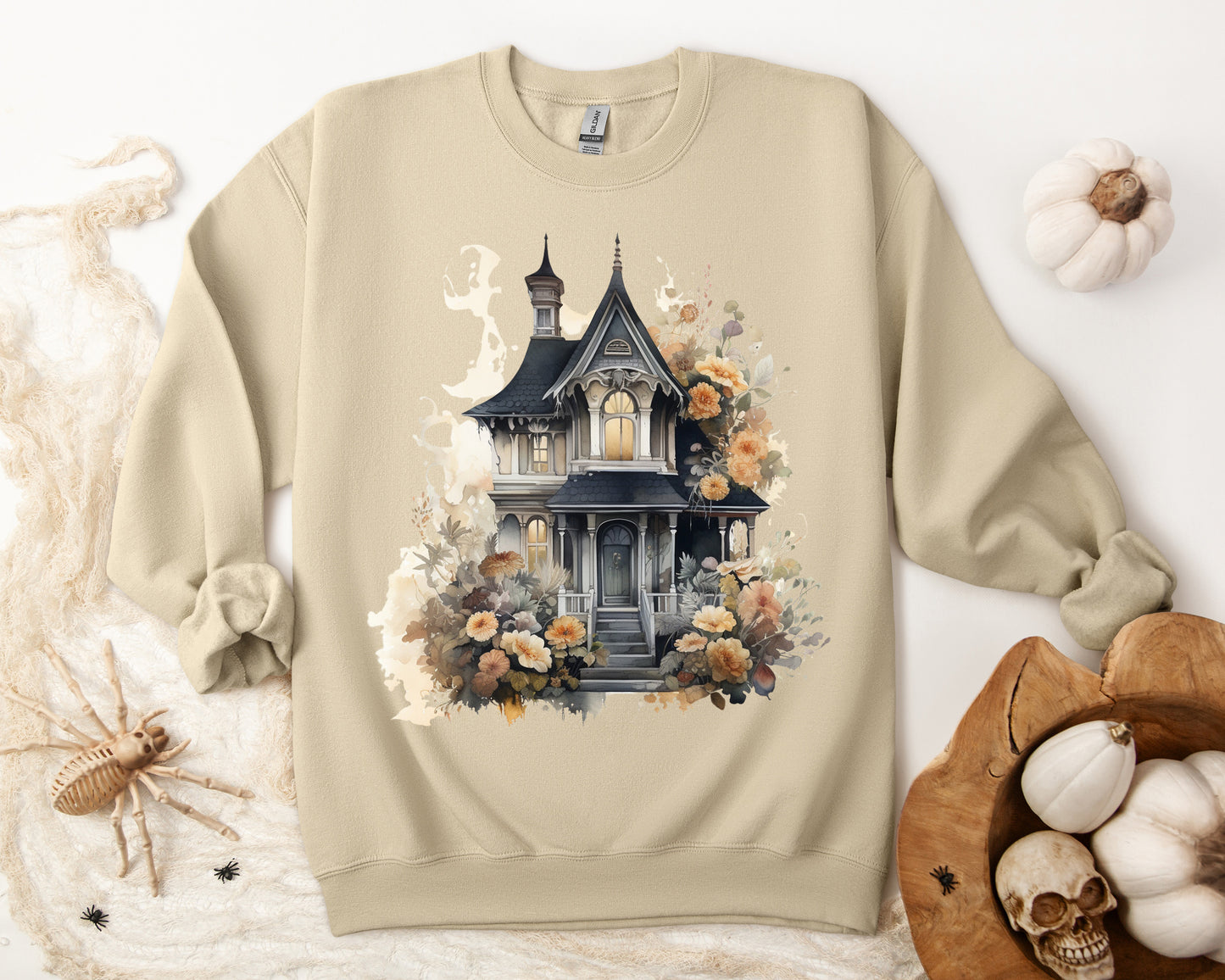 Halloween Boho Sweatshirt for Women featuring a haunted house illustration with boho design elements. Perfect for autumn festivities and casual wear. Gildan 18000 sweatshirt in Sand. ReadyShirtAim.com