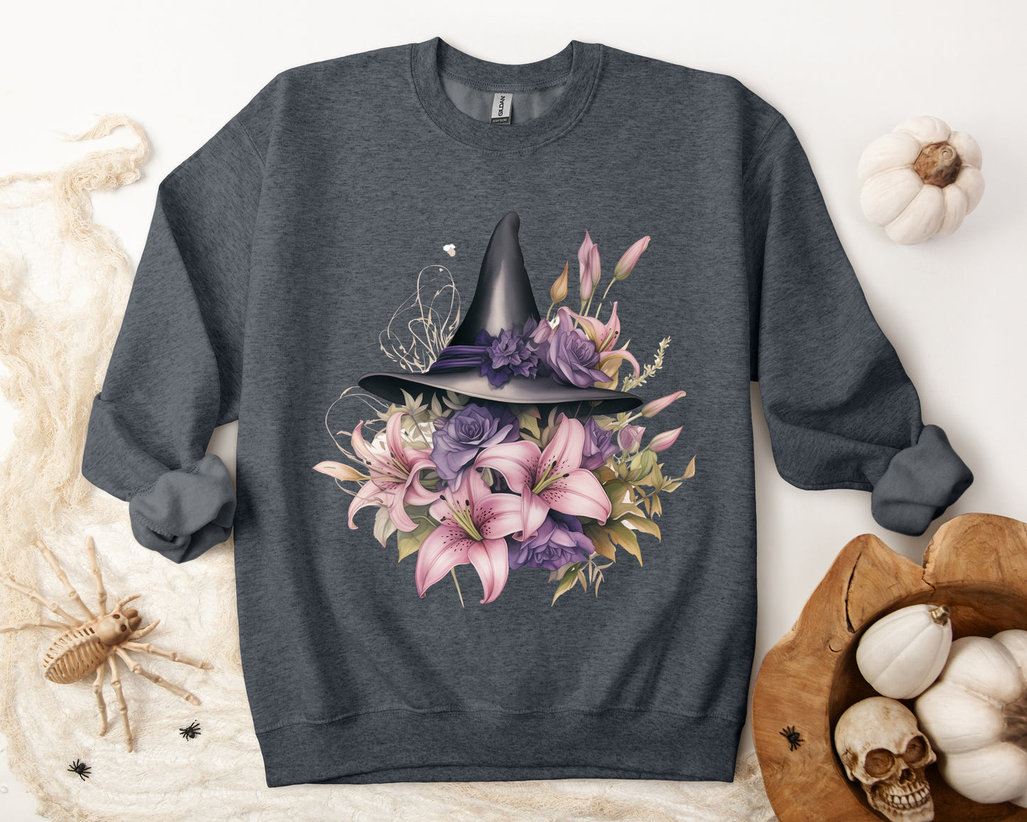 Enchanting Bohemian Witch Hat Sweatshirt with a watercolor illustration of a black witch hat surrounded by flowers in purple, pink, and green tones. Available in multiple dark ang light colors and sizes. Gildan 18000 sweatshirt in Dark Grey Heather. ReadyShirtAim.com