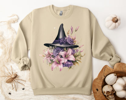 Enchanting Bohemian Witch Hat Sweatshirt with a watercolor illustration of a black witch hat surrounded by flowers in purple, pink, and green tones. Available in multiple dark ang light colors and sizes. Gildan 18000 sweatshirt in Sand. ReadyShirtAim.com