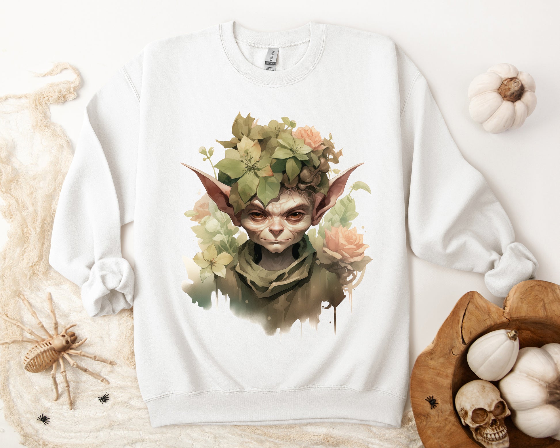 Whimsical Goblin & Floral Boho Halloween Sweatshirt for women. Features a charming goblin surrounded by delicate florals. Perfect for Halloween celebrations. Available in multiple dark and light colors and sizes. Gildan 18000 sweatshirt in white. ReadyShirtAim.com