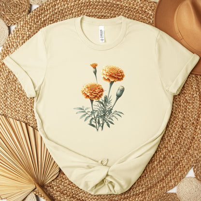 A t-shirt featuring a beautiful marigold for October. Perfect for October birthdays and floral art lovers. Comfortable and stylish for casual outings or celebrations. Bella+Canvas 3001 t-shirt in natural. ReadyShirtAim.com