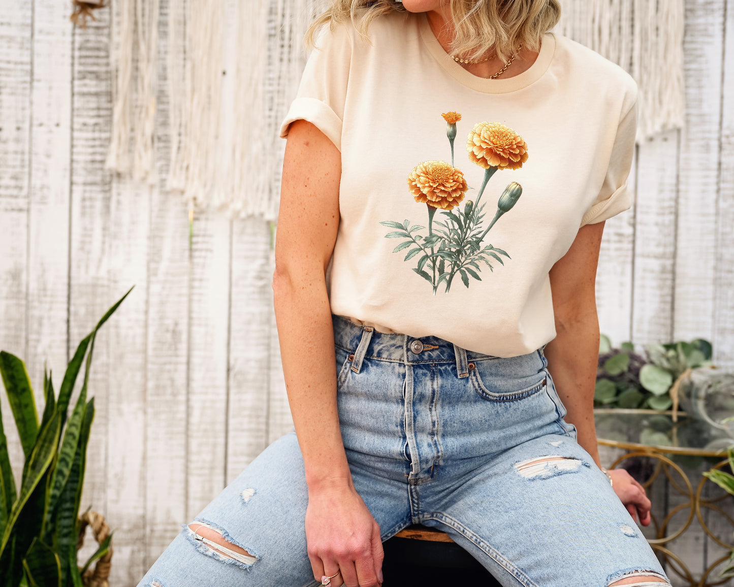 A t-shirt featuring a beautiful marigold for October. Perfect for October birthdays and floral art lovers. Comfortable and stylish for casual outings or celebrations. Bella+Canvas 3001 t-shirt in soft cream. ReadyShirtAim.com