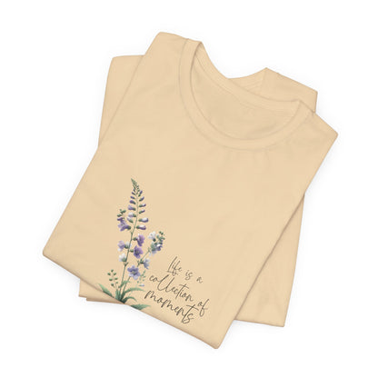 A t-shirt featuring a beautiful larkspur for July with the quote “Life is a collection of moments.” Perfect for July birthdays and floral art lovers. Comfortable and stylish for casual outings or celebrations. Bella+Canvas 3001 t-shirt in soft cream. ReadyShirtAim.com