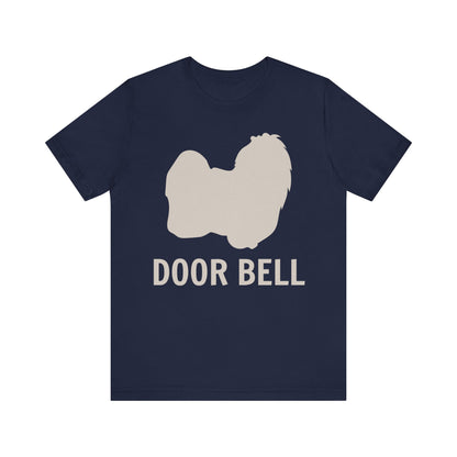 "Door Bell" Maltese Dog T-Shirt for Unisex with a beige silhouette of a Maltese dog and playful "Door Bell" text underneath. Ideal for dog lovers with a sense of humor. Bella+Canvas 3001 t-shirt in navy. ReadyShirtAim.com