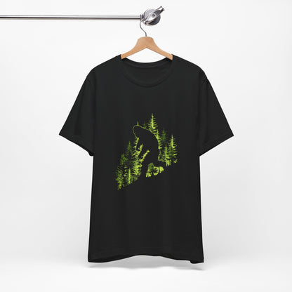 A t-shirt featuring an artistic depiction of a Bigfoot encounter, perfect for cryptid enthusiasts, outdoor adventurers, and mystery lovers. Comfortable and stylish for casual outings or cryptid conventions. Bella+Canvas 3001 t-shirt in black. ReadyShirtAim.com