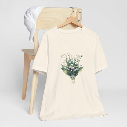 A t-shirt featuring a beautiful Lily of the Valley for May. Perfect for May birthdays and floral art lovers. Comfortable and stylish for casual outings or celebrations. Bella+Canvas 3001 t-shirt in natural. ReadyShirtAim.com