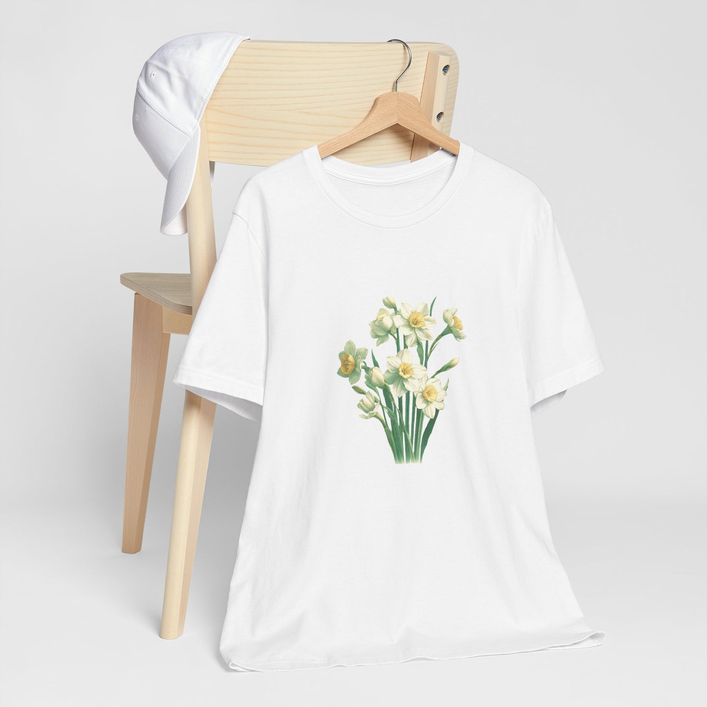 A t-shirt featuring a beautiful narcissus for December. Perfect for December birthdays and floral art lovers. Comfortable and stylish for casual outings or celebrations. Bella+Canvas 3001 t-shirt in white. ReadyShirtAim.com