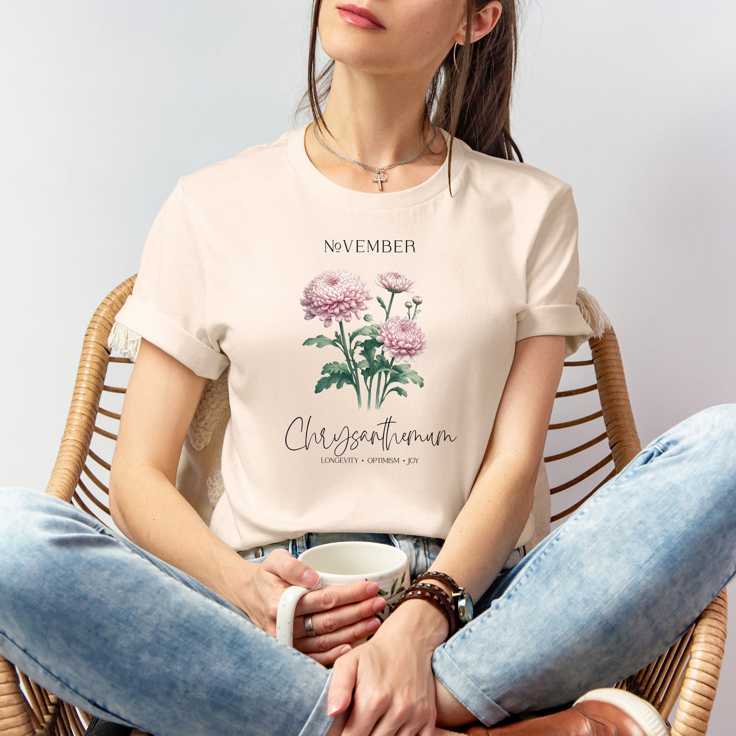 A t-shirt featuring a beautiful chrysanthemum for November with traits Longevity, Optimism, Joy. Perfect for November birthdays and floral art lovers. Comfortable and stylish for casual outings or celebrations. Bella+Canvas 3001 t-shirt in soft cream. ReadyShirtAim.com