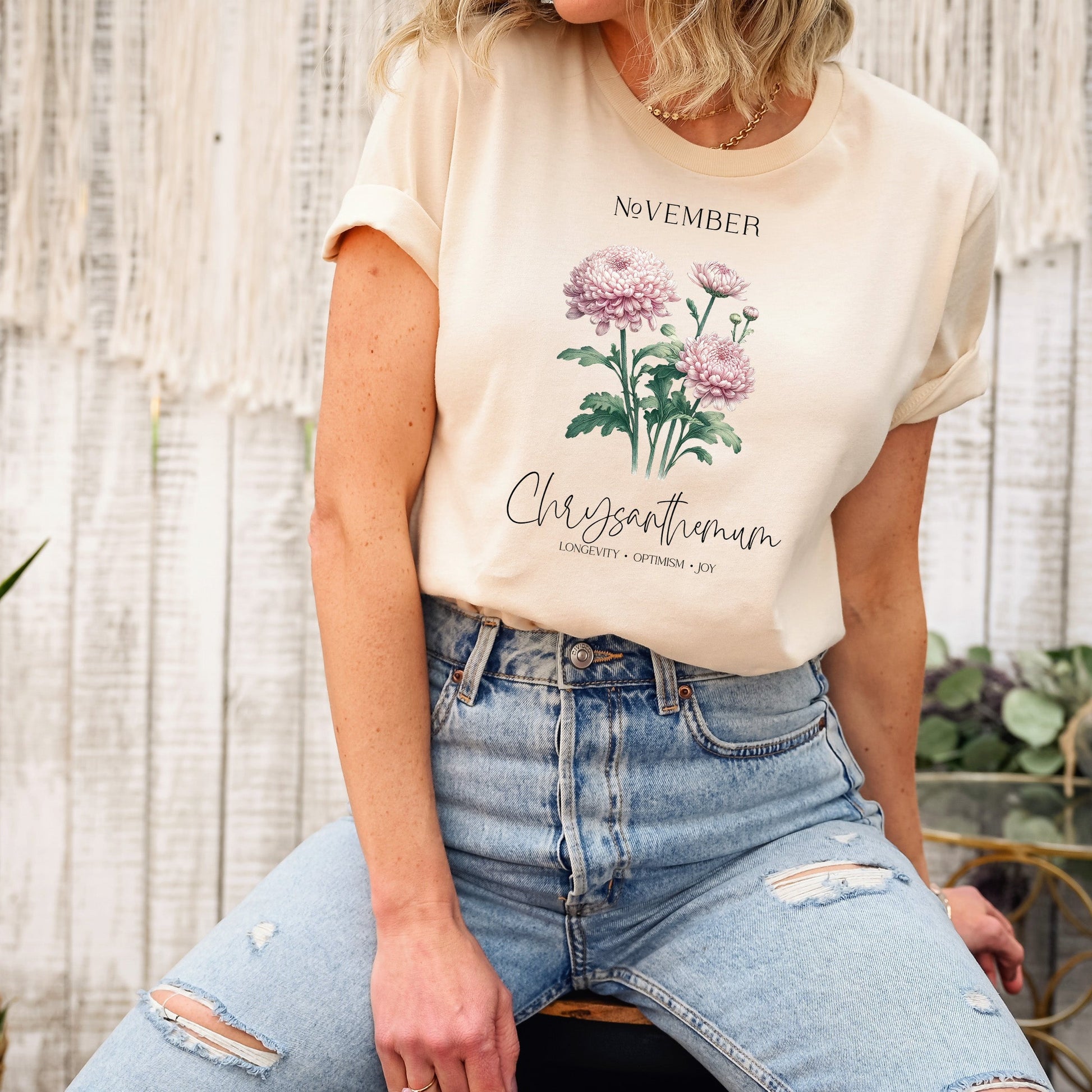 A t-shirt featuring a beautiful chrysanthemum for November with traits Longevity, Optimism, Joy. Perfect for November birthdays and floral art lovers. Comfortable and stylish for casual outings or celebrations. Bella+Canvas 3001 t-shirt in soft cream. ReadyShirtAim.com