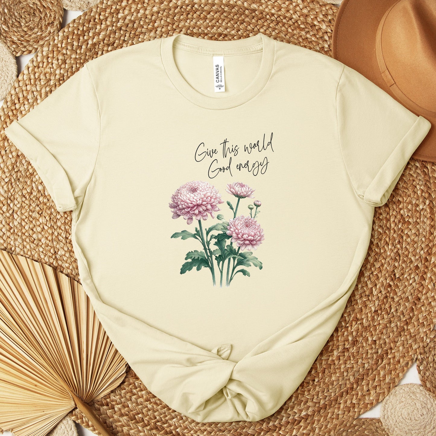 A t-shirt featuring a beautiful chrysanthemum for November with the quote “Give this world good energy.” Perfect for November birthdays and floral art lovers. Comfortable and stylish for casual outings or celebrations. Bella+Canvas 3001 t-shirt in natural. ReadyShirtAim.com