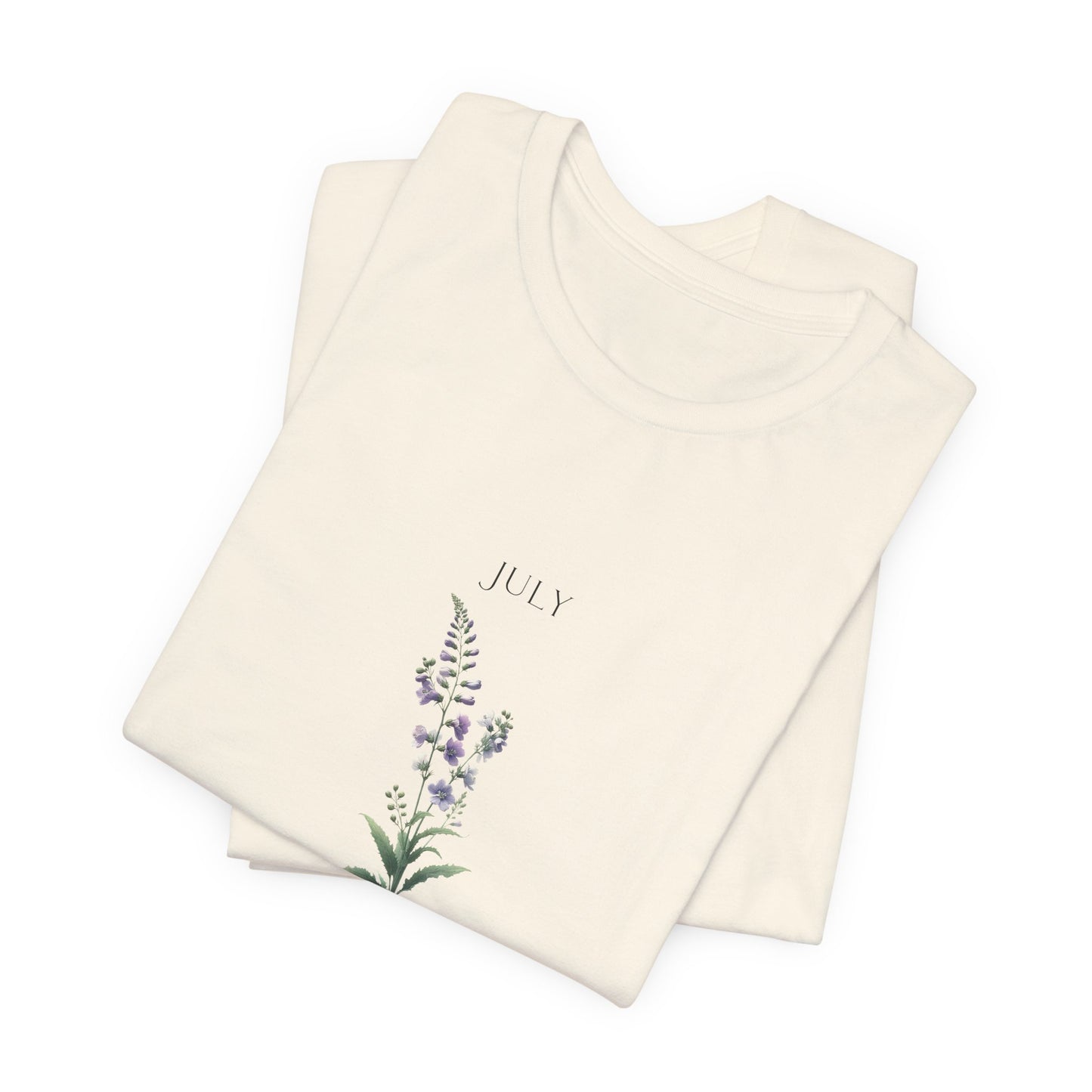 A t-shirt featuring a beautiful larkspur for July with traits Positive, Grace, First Love. Perfect for July birthdays and floral art lovers. Comfortable and stylish for casual outings or celebrations. Bella+Canvas 3001 t-shirt in natural. ReadyShirtAim.com