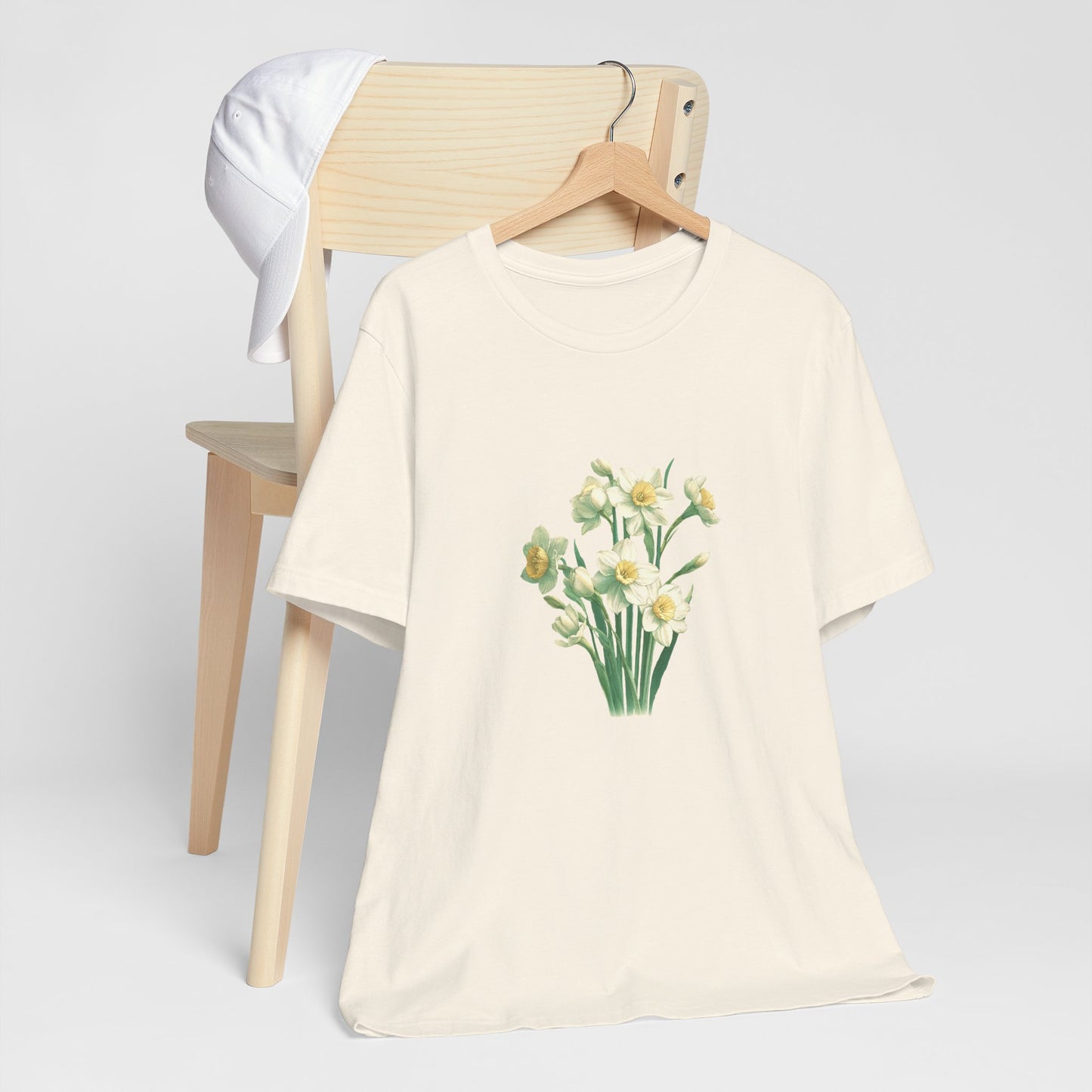 A t-shirt featuring a beautiful narcissus for December. Perfect for December birthdays and floral art lovers. Comfortable and stylish for casual outings or celebrations. Bella+Canvas 3001 t-shirt in natural. ReadyShirtAim.com