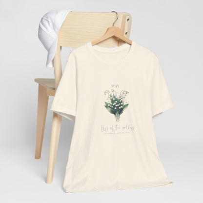 A t-shirt featuring a beautiful Lily of the Valley for May with traits Motherhood, Sweetness, Purity. Perfect for May birthdays and floral art lovers. Comfortable and stylish for casual outings or celebrations. Bella+Canvas 3001 t-shirt in natural. ReadyShirtAim.com