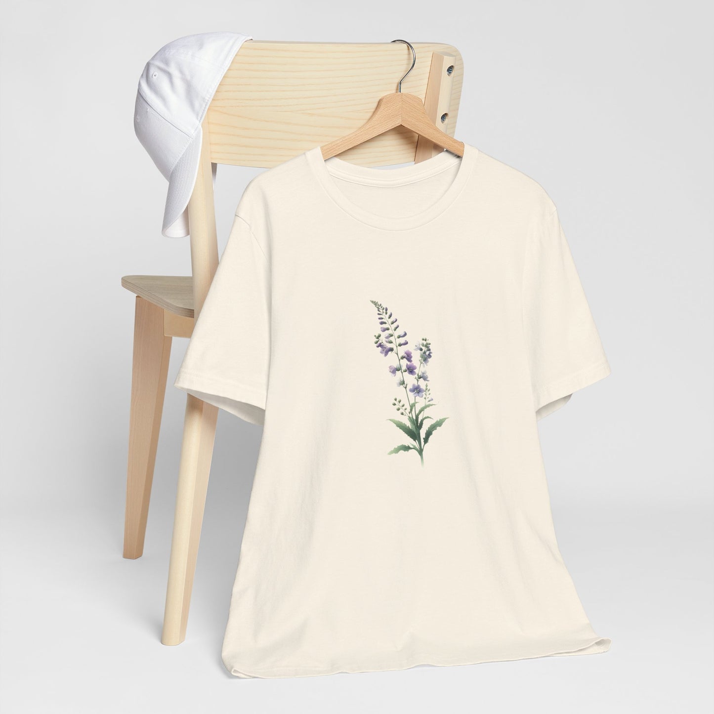 A t-shirt featuring a beautiful larkspur for July. Perfect for July birthdays and floral art lovers. Comfortable and stylish for casual outings or celebrations. Bella+Canvas 3001 t-shirt in natural. ReadyShirtAim.com