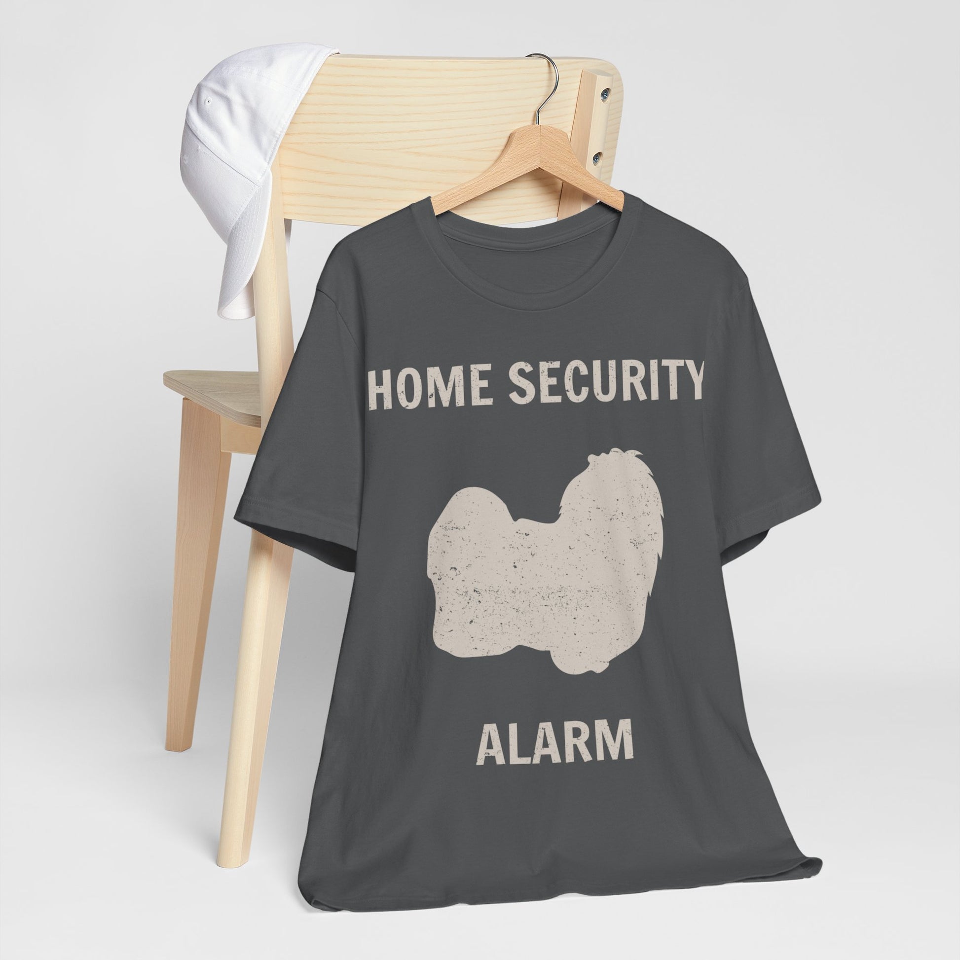 Funny Dog Lovers T-Shirt with an adorable Maltese illustration and "home security alarm" text, perfect for Maltese moms and fur baby parents. Unisex fit for men and women. Available in multiple colors and sizes. Bella+Canvas 3001 t-shirt in asphalt. ReadyShirtAim.com