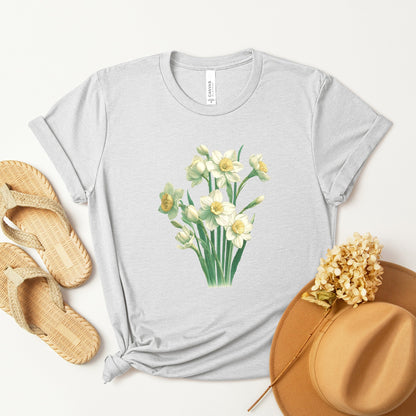 A t-shirt featuring a beautiful narcissus for December. Perfect for December birthdays and floral art lovers. Comfortable and stylish for casual outings or celebrations. Bella+Canvas 3001 t-shirt in white. ReadyShirtAim.com