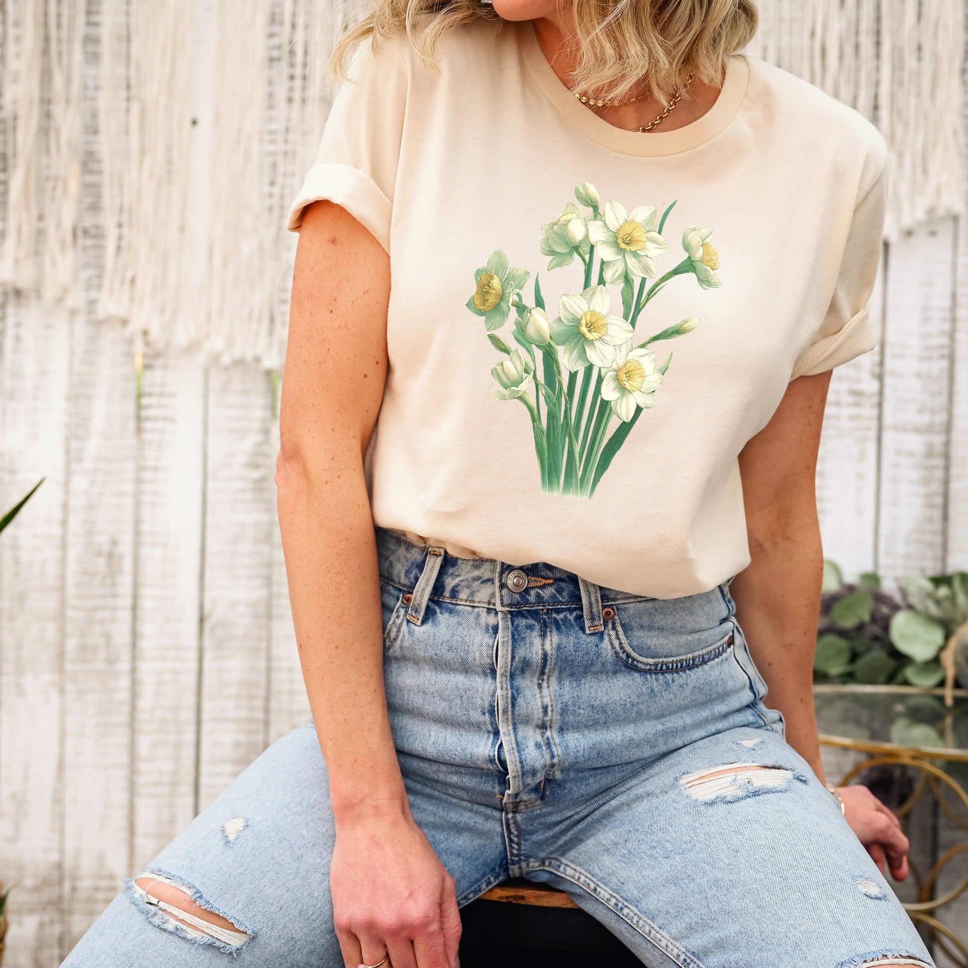 A t-shirt featuring a beautiful narcissus for December. Perfect for December birthdays and floral art lovers. Comfortable and stylish for casual outings or celebrations. Bella+Canvas 3001 t-shirt in soft cream. ReadyShirtAim.com