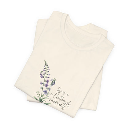 A t-shirt featuring a beautiful larkspur for July with the quote “Life is a collection of moments.” Perfect for July birthdays and floral art lovers. Comfortable and stylish for casual outings or celebrations. Bella+Canvas 3001 t-shirt in natural. ReadyShirtAim.com