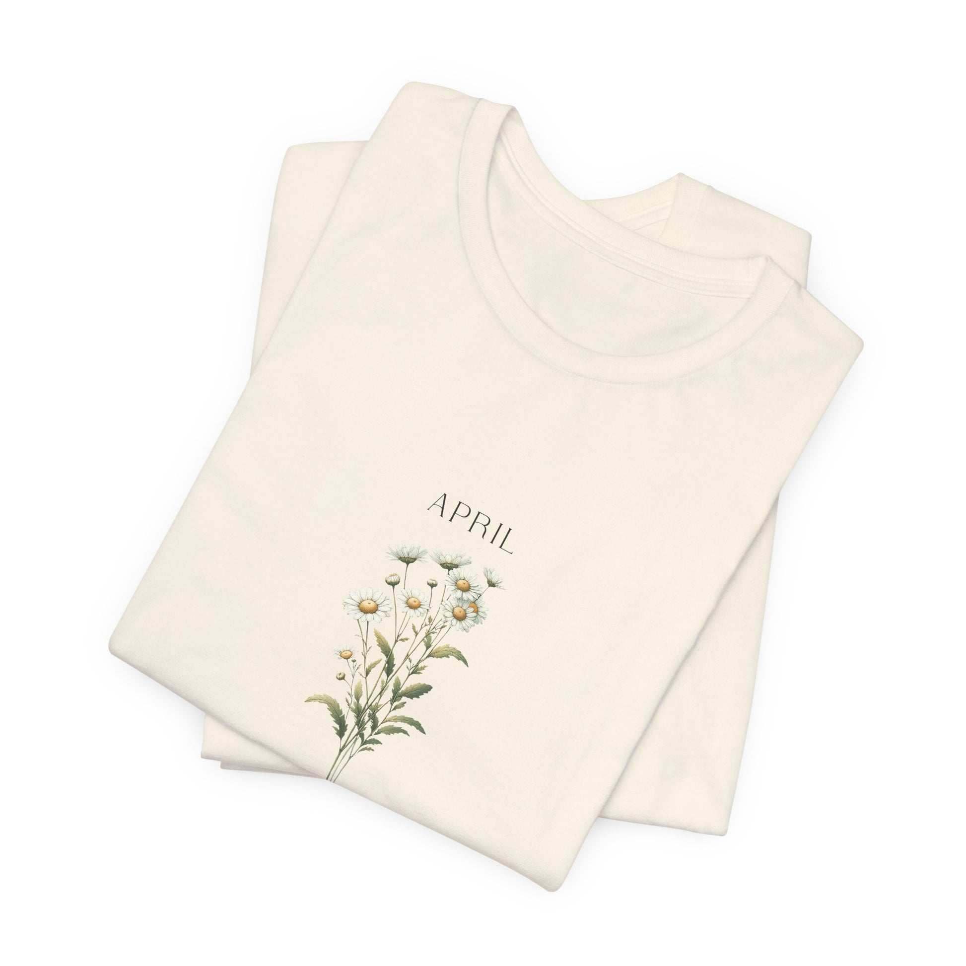 A t-shirt featuring a beautiful daisy for April with traits Purity, Innocence, Loyalty. Perfect for April birthdays and floral art lovers. Comfortable and stylish for casual outings or celebrations. Bella+Canvas 3001 t-shirt in natural. ReadyShirtAim.com