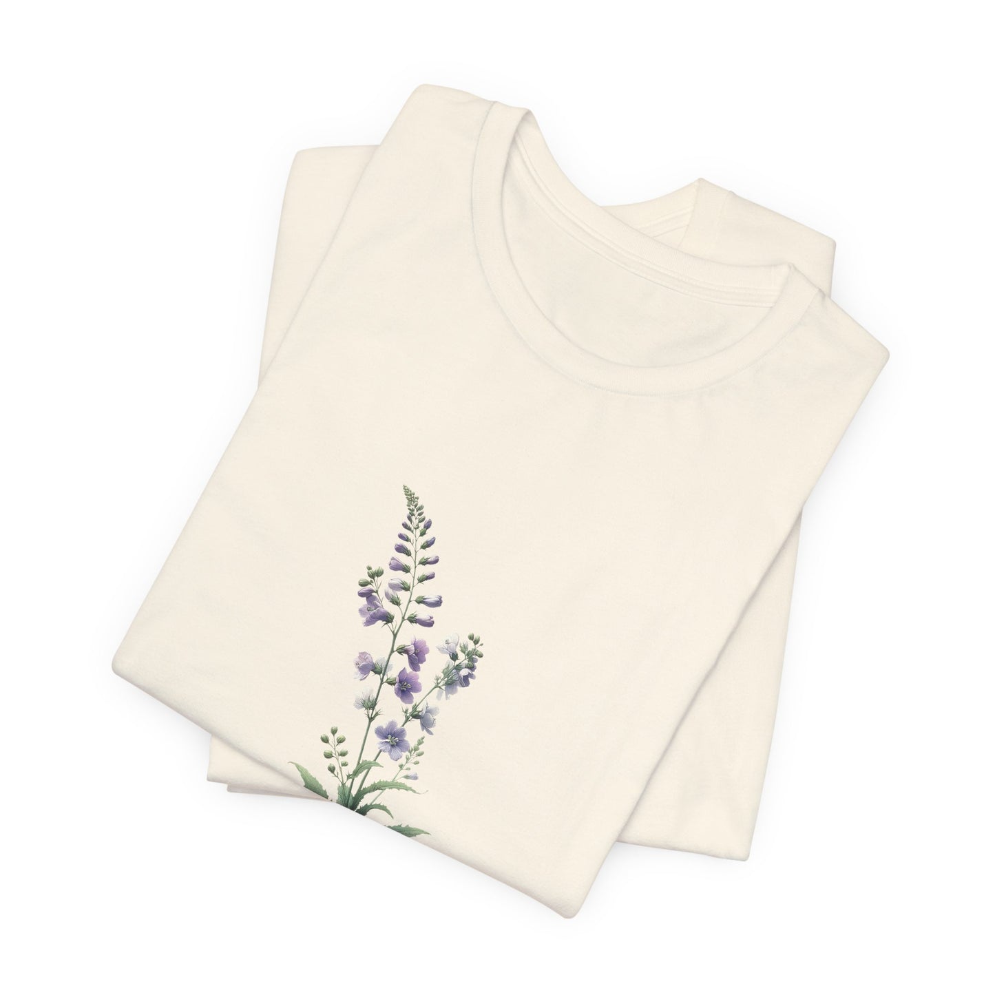 A t-shirt featuring a beautiful larkspur for July. Perfect for July birthdays and floral art lovers. Comfortable and stylish for casual outings or celebrations. Bella+Canvas 3001 t-shirt in natural. ReadyShirtAim.com