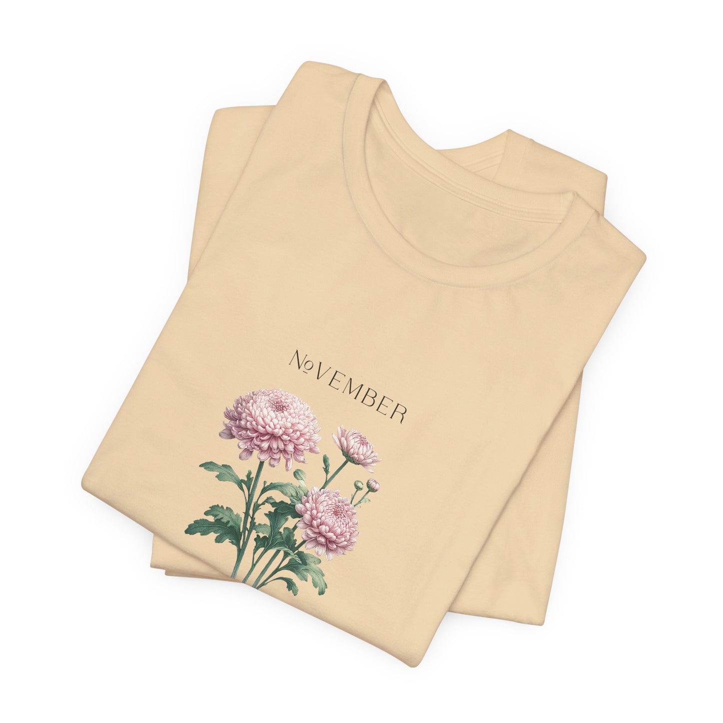 A t-shirt featuring a beautiful chrysanthemum for November with traits Longevity, Optimism, Joy. Perfect for November birthdays and floral art lovers. Comfortable and stylish for casual outings or celebrations. Bella+Canvas 3001 t-shirt in soft cream. ReadyShirtAim.com