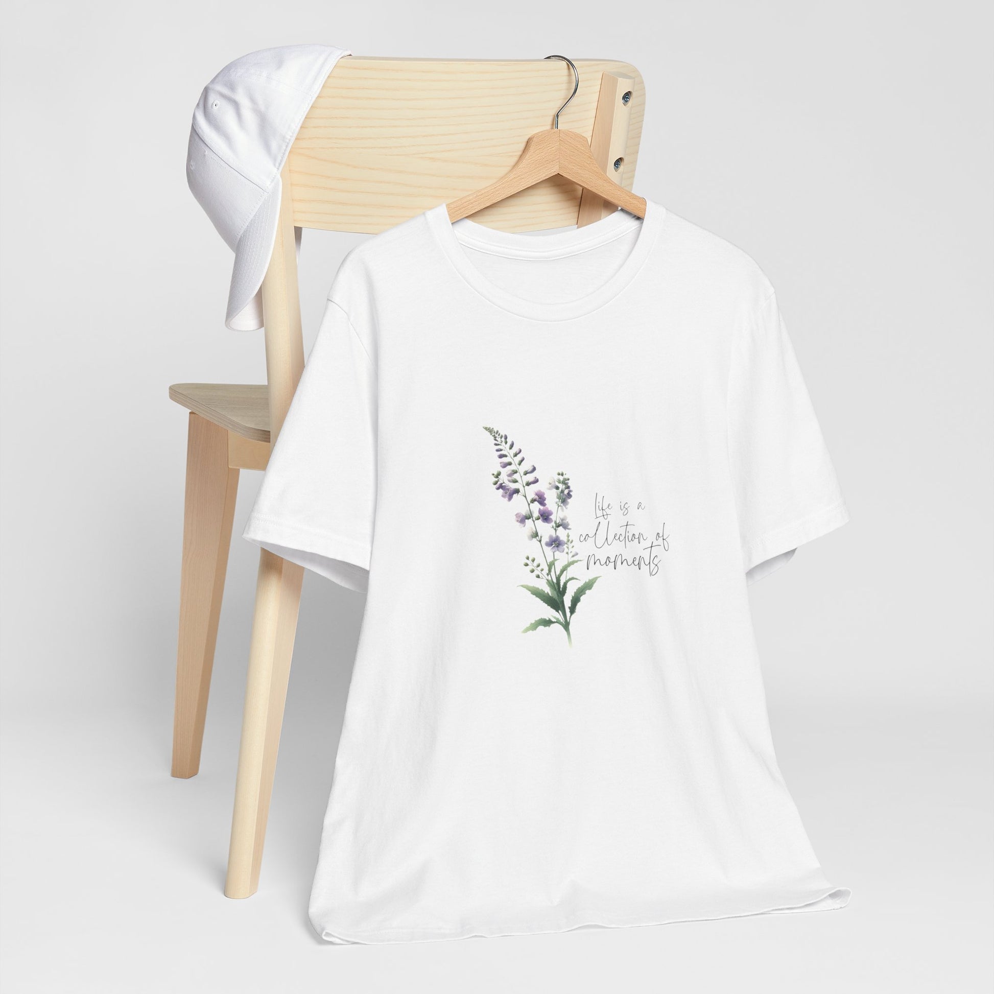 A t-shirt featuring a beautiful larkspur for July with the quote “Life is a collection of moments.” Perfect for July birthdays and floral art lovers. Comfortable and stylish for casual outings or celebrations.. Bella+Canvas 3001 t-shirt in white. ReadyShirtAim.com