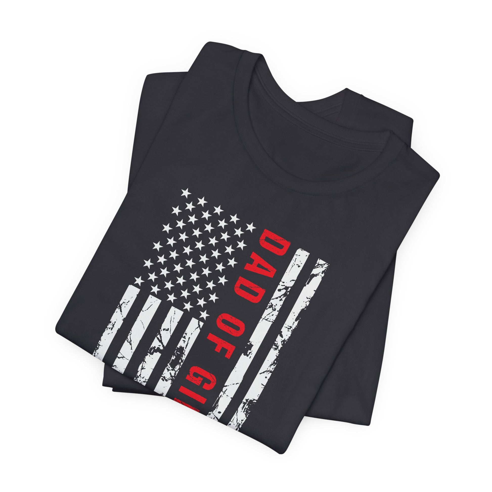 A dark-colored t-shirt featuring a grungy American flag design with the text "Dad of girls #outnumbered" in white and red. Perfect for Father's Day, Fourth of July, and patriotic dads who love humor. Comfortable and stylish for casual wear. Bella+Canvas 3001 t-shirt in dark grey. ReadyShirtAim.com